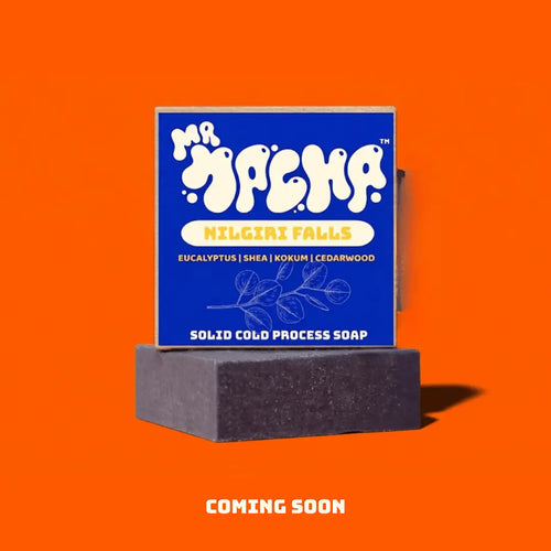 Solid cold process soap bar with blue packaging on an orange background